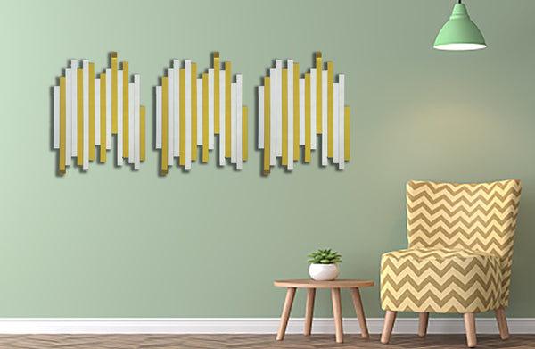 Luxe panel gold mirrors styled in living room with green wall and modern patterned chair.