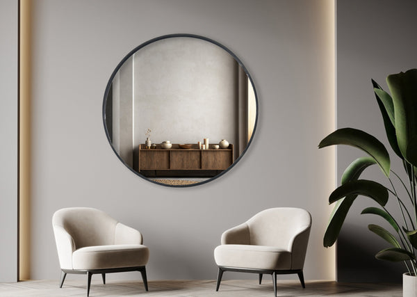 Black round wall mirror styled above modern lounge with two armchairs