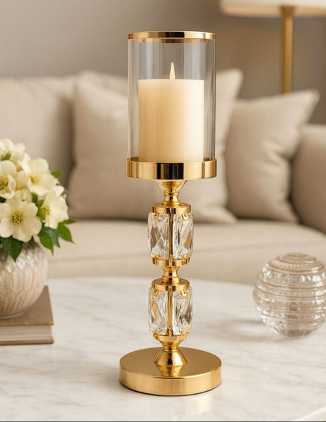 Gold candle holder with a candle on a table in a living room setting