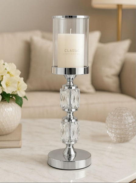 Decorative candle holder with a candle on a table in a living room setting.