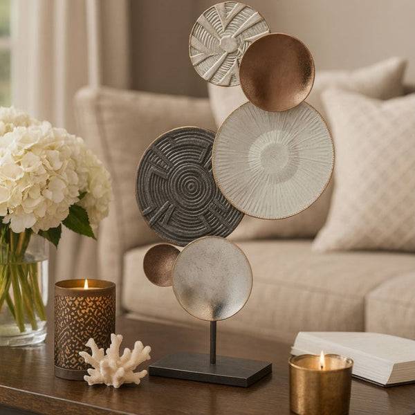Abstract table decor on a coffee table with flower vase and candles in a living room setting