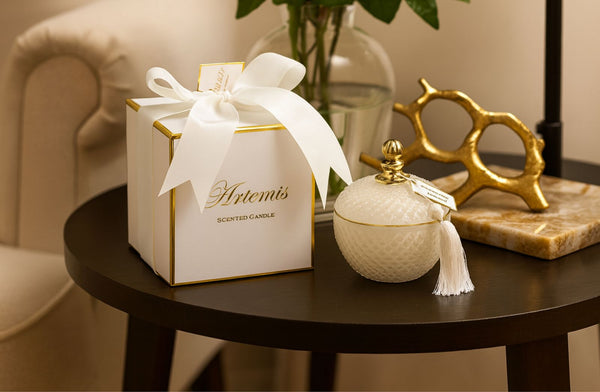Decorative candle and box on a table with a blurred background