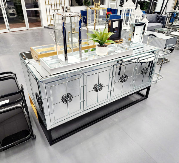 Mirrored Athens buffet sideboard displayed in showroom with decorative lanterns and plants, stylish statement.