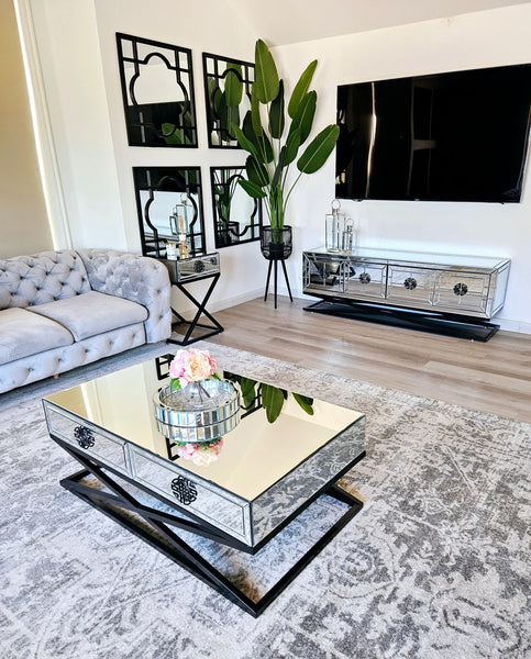 Stylish Athens mirrored coffee table with black metal base, complementing chic modern living room.