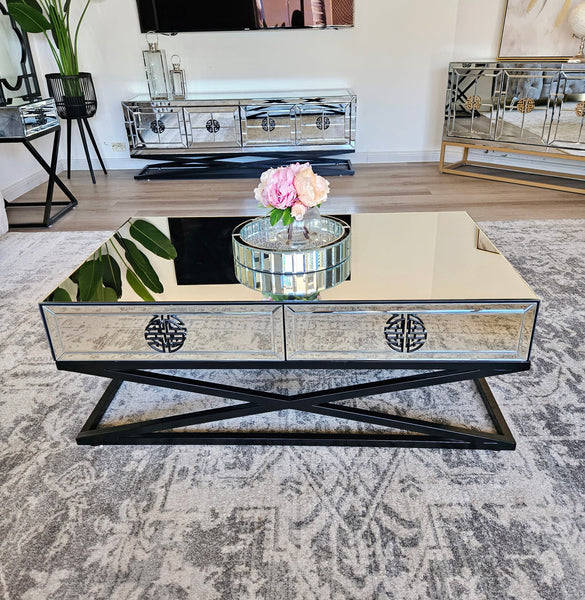 Athens mirrored coffee table styled with flowers, adding modern luxury to living room décor.