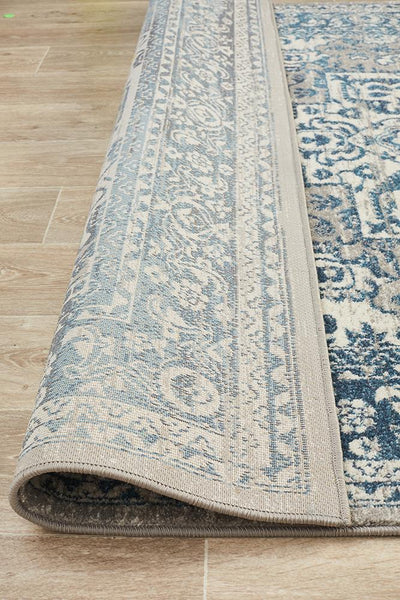 Folded edge of Babylon Blue Rug showing intricate border design