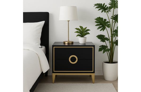 Black Balmain bedside table with gold trim styled beside bed with lamp and indoor plant.