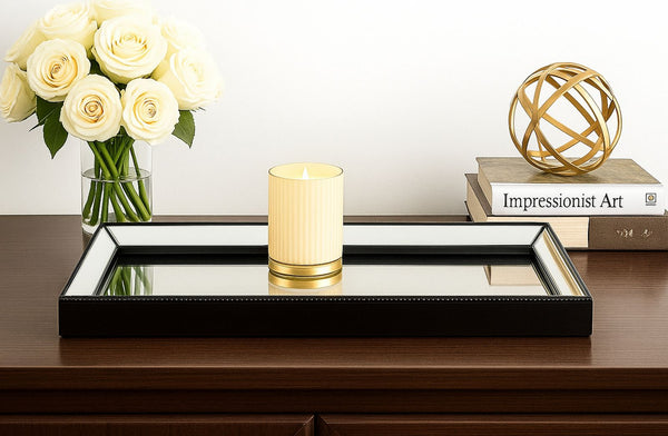 Decorative Mirrored Medium Black Tray a vase of white roses, candle, and decorative sphere on a table.