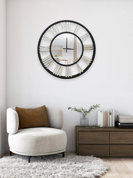 Black mirrored beaded wall clock styled in living room above armchair and cabinet décor.