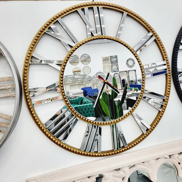 Decorative gold beaded mirrored Roman numeral wall clock displayed in showroom with mirrors.