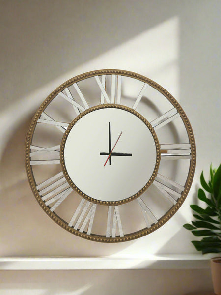 Gold beaded mirrored wall clock styled with plant décor, elegant and timeless wall accent.
