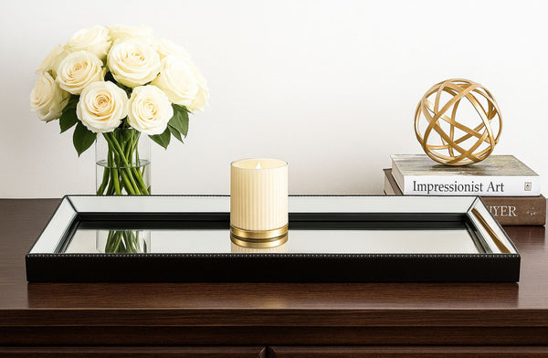 Decorative Beaded Black Tray on a console table with flowers, candle, and sculpture.
