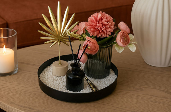 Decorative tray with flowers, decorative, and decorative items on a wooden coffee table.