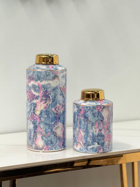  Blossom Marble Ceramic Canisters displayed on a gold-accented table – features pastel marble texture with glossy gold lids for modern home décor