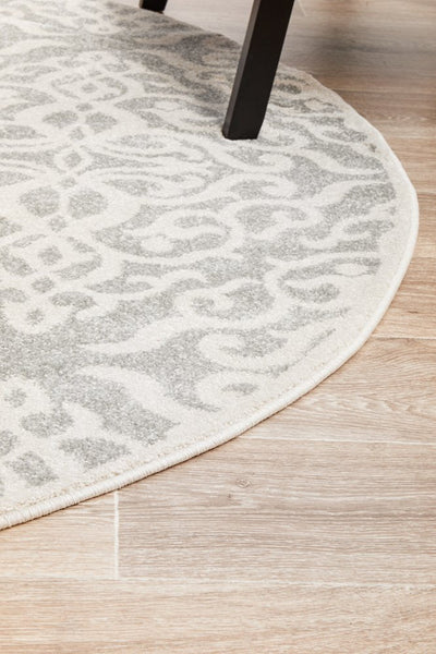 Curved edge of round Chrome Lydia Silver Rug on floor