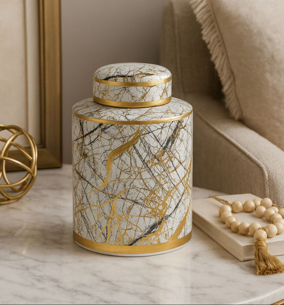 Decorative cylindrical container with marble pattern on a table