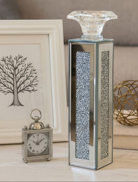 Decorative table candle holder with crystal base and clock on a neutral background