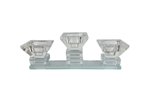 Elegant crystal-clear tea light candle holder with three diamond-shaped cups on a rectangular base.