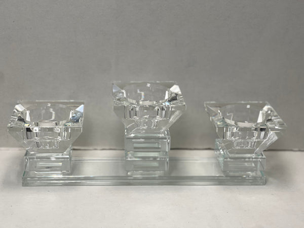 Three-cup crystal tea light holder on a glass base, displayed against a neutral background.