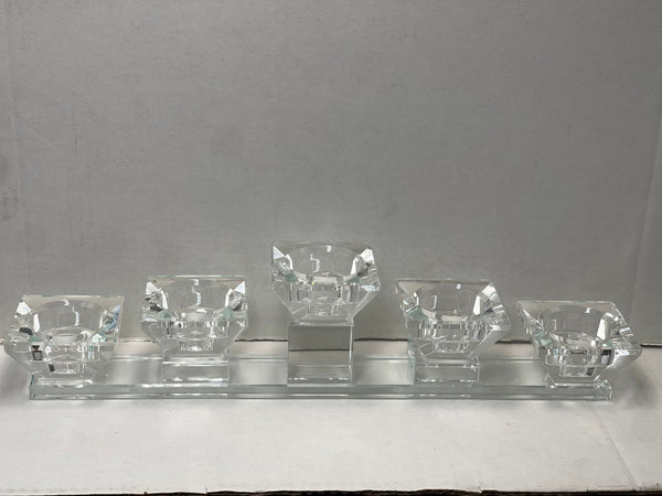 Crystal-clear tea light candle holder with five diamond-shaped cups on a long rectangular base
