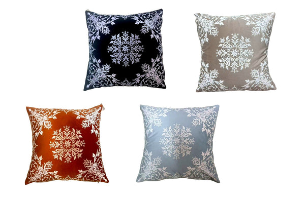 Set of four damask velvet cushions in black, beige, grey, and burnt orange.