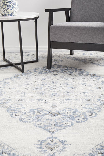 Emotion 77 Blue Rug styled in a modern living space with grey chair