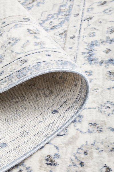 Folded edge of Emotion 77 Blue Rug showing soft pile and weave