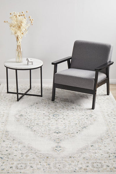 Emotion 77 Green Rug styled with grey armchair and marble side table – a soft, calming rug ideal for living or reading spaces