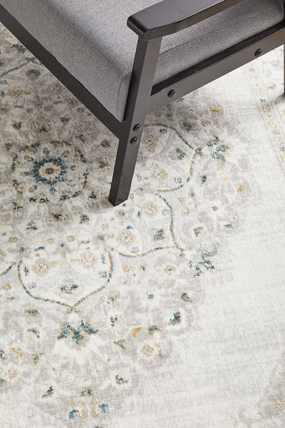 Close-up of Emotion 77 Green Rug showing elegant woven texture and subtle green floral detailing on cream base
