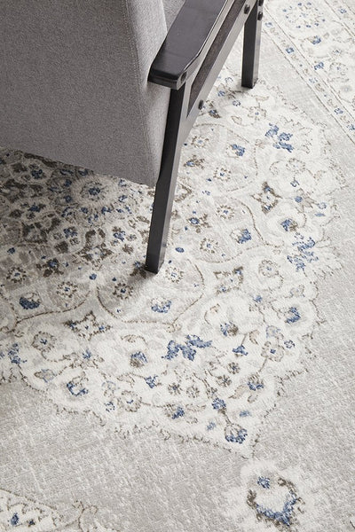Close-up of the Emotion 77 Silver Rug corner showing delicate patterns and soft silver hues on a plush surface.

