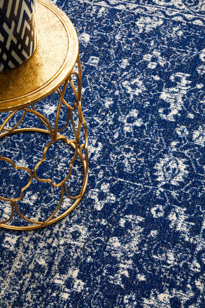 Detailed pattern of Evoke 252 Navy Rug under gold decorative table