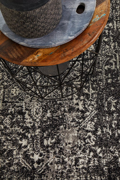 Close-up of Evoke Charcoal Rug under side table décor