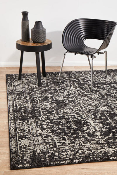 Evoke Charcoal Rug styled in modern living room with black chair