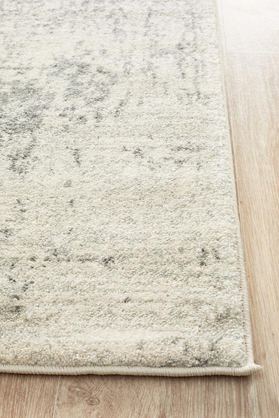 Thick serge edge of white silver rug on wooden floor