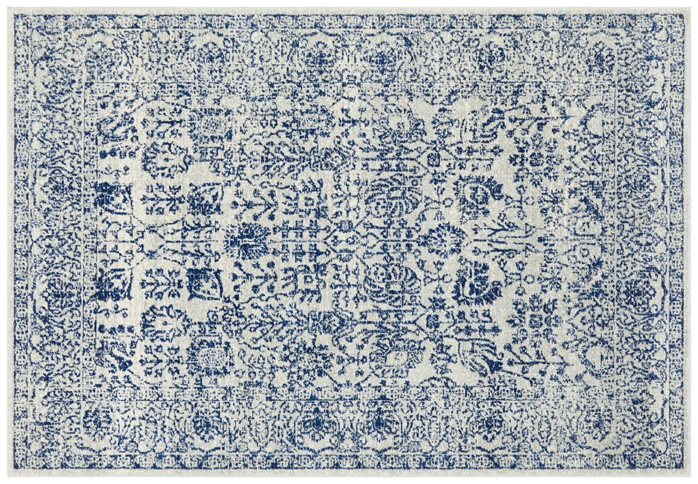 Traditional ivory rug with navy distressed floral motifs, perfect statement piece for classic home interiors.