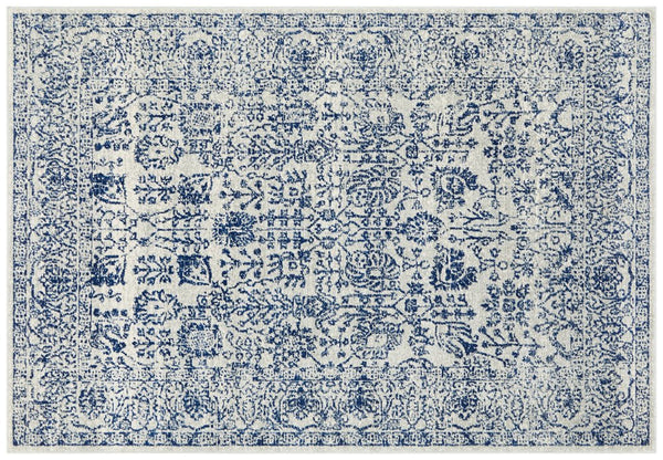 Traditional ivory rug with navy distressed floral motifs, perfect statement piece for classic home interiors.