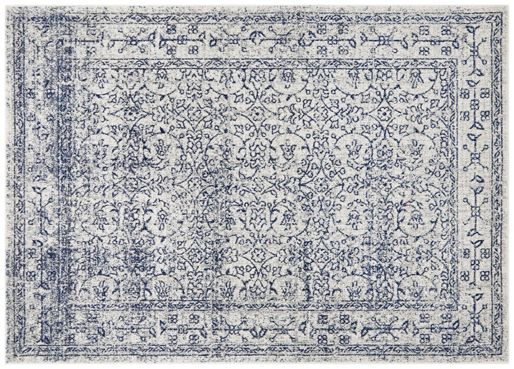 Classic ivory rug with navy floral motifs, detailed distressed pattern ideal for elegant interiors.
