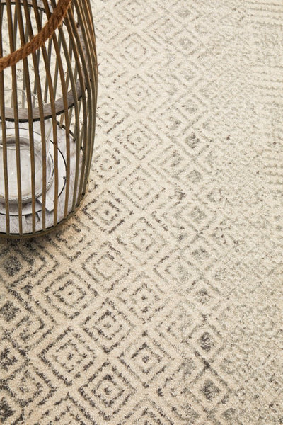 Detailed view of Evoke 265 Grey Rug with lantern décor, showcasing intricate diamond design.
