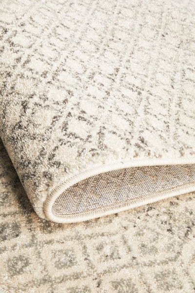 Folded edge of Evoke 265 Grey Rug highlighting its thick pile and durable polypropylene weave.
