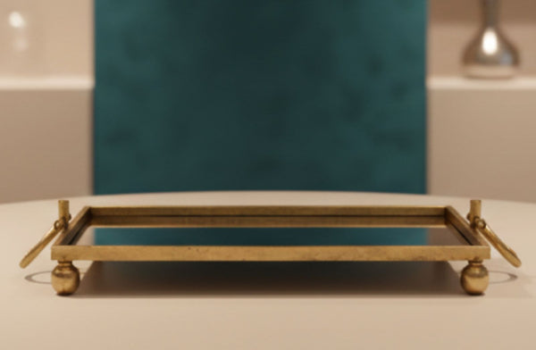 Go;d mirror tray on a table with a blurred background