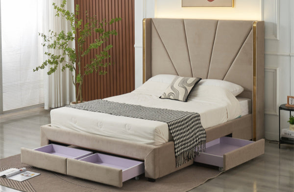 Angled view of champagne velvet Elwood bed with gold accents and open storage drawers.
