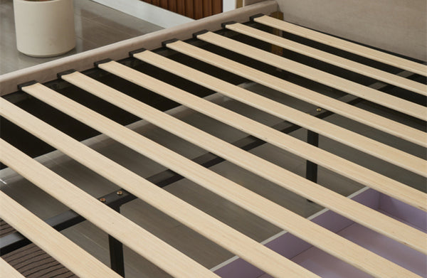 Close-up of Elwood bed’s wooden slat base and storage drawer structure in champagne velvet.