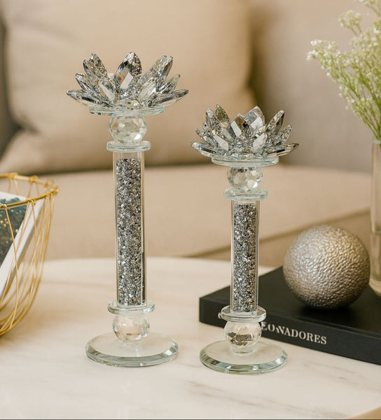 Two decorative candle holders with crystal embellishments on a table.