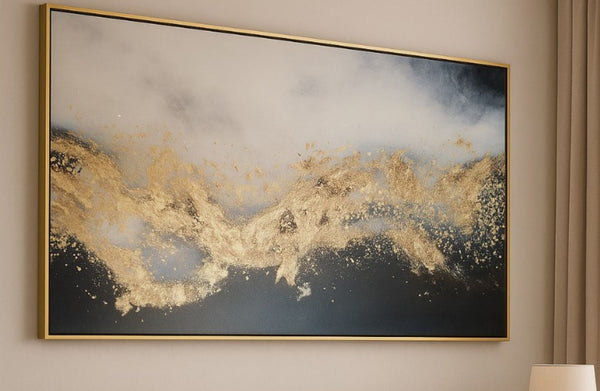 Abstract art piece with gold and black design on a wall