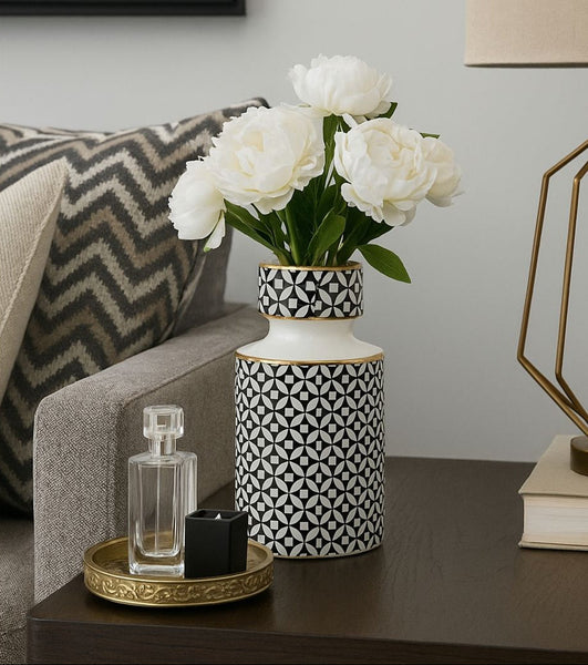 Decorative vase with white flowers on a table next to a couch