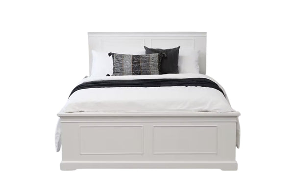 Hamptons white panelled bed frame with coastal-inspired design, styled with bedding and accent pillows.