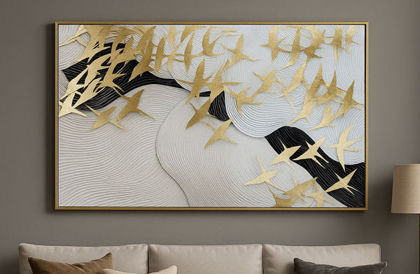 Decorative wall art with gold leaf design on a gray wall above a sofa.