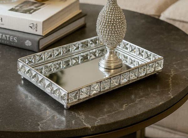 Decorative mirror silver tray with a matching pedestal on a marble table