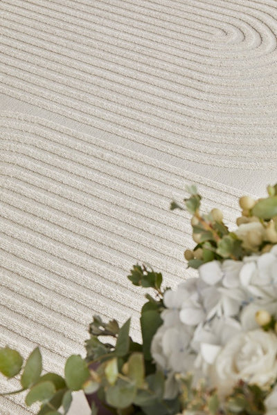 Beautiful beige rug texture with curved patterns, enhancing modern and classic home décor.