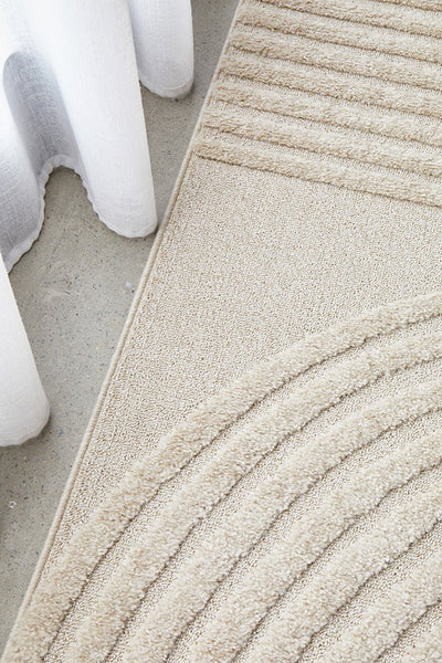 Close-up of beige rug corner showcasing detailed texture and premium craftsmanship.